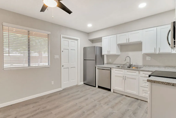 Phoenix apartment for rent - an empty kitchen with white cabinets and a stainless steel refrigerator
