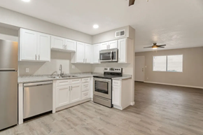 Phoenix apartment for rent - an empty kitchen with white cabinets and stainless steel appliances