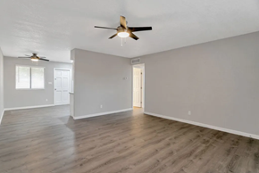 Phoenix apartment for rent - the living room and dining room of an empty house with a ceiling fan