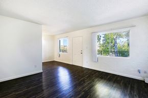 Scottsdale apartment for rent - A room with a white door and a window with a view of trees outside.