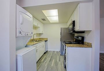 Mesa apartment for rent - A kitchen with white appliances and cabinets.