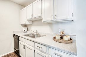 Flagstaff apartment for rent - the preserve at ballantyne commons apartment kitchen with sink and white cabinets
