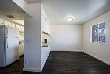 Phoenix apartment for rent - A kitchen with a refrigerator and a countertop with a window.