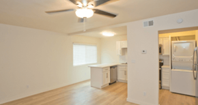 Phoenix apartment for rent - A white kitchen with a ceiling fan and a window.