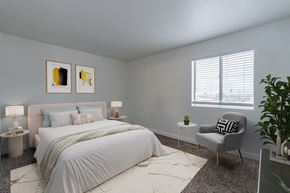 Phoenix apartment for rent - A bedroom with a large bed and a chair.