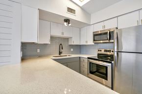 Phoenix apartment for rent - a kitchen with stainless steel appliances and white cabinets