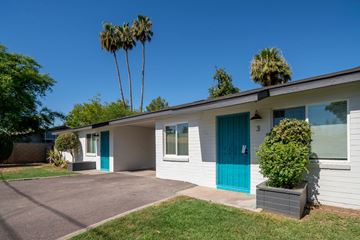 Phoenix apartment for rent - A house with a blue door and a green plant in front.