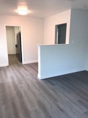 Phoenix apartment for rent - an empty living room with a blue wall and wood floors