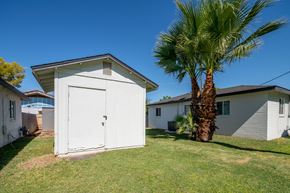 Phoenix apartment for rent - a small white shed with a palm tree in a yard in front of a house