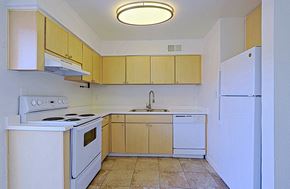 Scottsdale apartment for rent - A kitchen with white appliances and wooden cabinets.