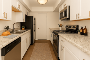 Phoenix apartment for rent - A kitchen with black appliances and white cabinets.