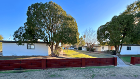 Phoenix apartment for rent - a red fence surrounds a yard in front of a house