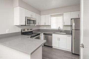 Phoenix apartment for rent - a kitchen with white cabinets and stainless steel appliances