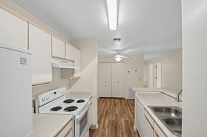 Yuma apartment for rent - A kitchen with a stove top oven and a sink.