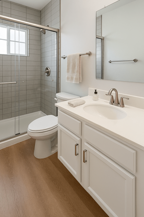 Phoenix apartment for rent - A white toilet sits in a bathroom next to a walk-in shower.