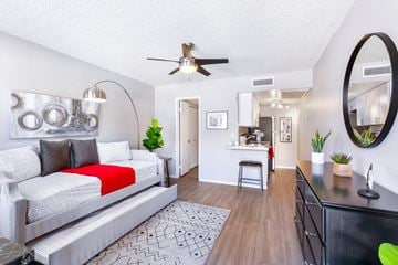 Phoenix apartment for rent - A modern living room with a white sofa and a red throw on it.