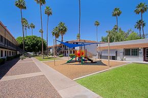 Mesa apartment for rent - A playground with a slide and a swing set at Aspire Mesa, Mesa,  Arizona.