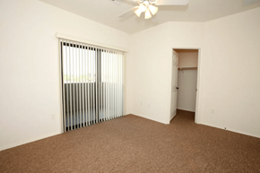 Surprise apartment for rent - A room with a carpeted floor, a ceiling fan, and a window with blinds.