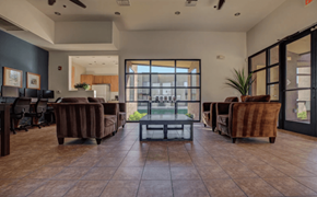 Surprise apartment for rent - A spacious office with brown leather chairs and a glass table.