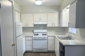 Phoenix townhouse for rent - A white kitchen with a stove, sink, and cabinets. at Connect on Missour Apartments, Phoenix, AZ