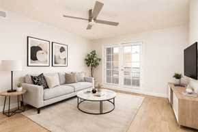 Phoenix apartment for rent - A living room with a grey couch, a coffee table, and a ceiling fan.