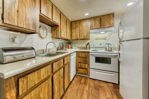Glendale apartment for rent - a kitchen with white appliances and wooden cabinets at Connect on Northern, Arizona