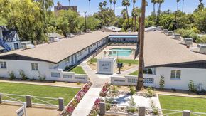 Phoenix apartment for rent - an aerial view of a white house with a pool and trees