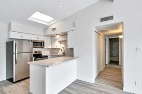 Phoenix apartment for rent - a white kitchen with stainless steel appliances and a large island