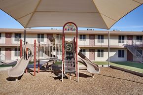 Phoenix apartment for rent - A playground with a slide and a sign that says "Villagio".