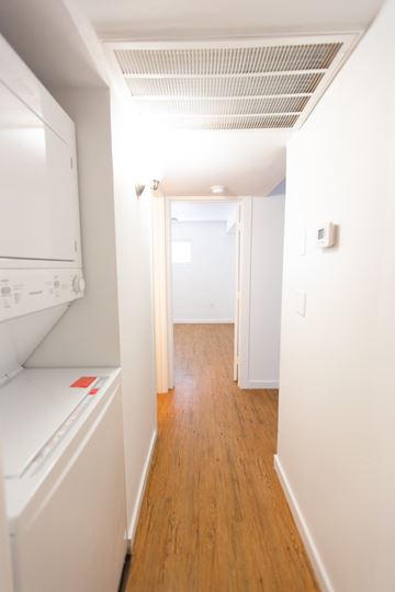 Tempe apartment for rent - a renovated kitchen with white cabinets and white appliances and a wood floor