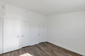 Phoenix apartment for rent - a bedroom with white walls and wooden floors and two closets