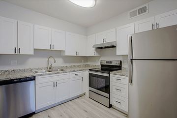 Phoenix apartment for rent - a kitchen with white cabinets and stainless steel appliances