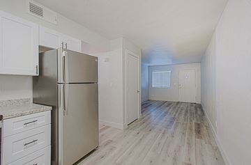 Phoenix apartment for rent - a renovated kitchen with stainless steel appliances and white cabinets