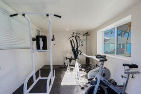 Phoenix apartment for rent - A home gym with a rowing machine, a stationary bike, and a treadmill.