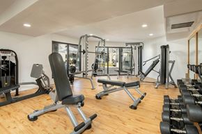Phoenix apartment for rent - A gym with a variety of equipment including weights and machines.