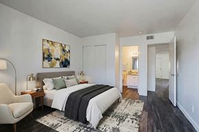 Phoenix apartment for rent - A bedroom with a large bed and a chair.