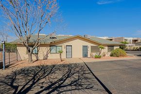 Phoenix apartment for rent - A building with a green roof and a tree in front of it.