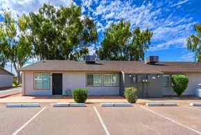 Goodyear apartment for rent - A building with a parking lot in front of it.