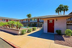 Phoenix apartment for rent - A red door is on the right side of a building.