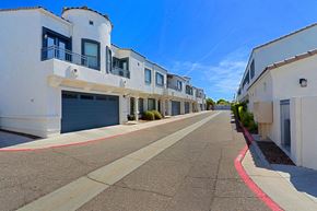 Phoenix townhouse for rent - A row of white buildings with balconies and garage doors.
