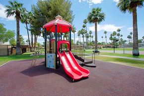 Phoenix apartment for rent - a playground with a red slide and monkey bars