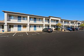 Phoenix apartment for rent - an apartment building with a parking lot and cars in front of it