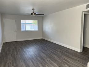 Phoenix apartment for rent - an empty living room with wooden floors and a ceiling fan