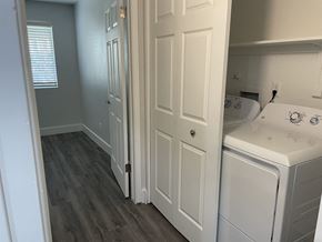 Phoenix apartment for rent - a laundry room with white cabinets and a washer and dryer