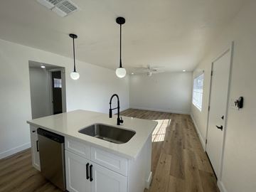 Phoenix apartment for rent - a kitchen and living room with white cabinets and a sink