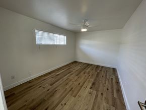 Phoenix apartment for rent - an empty living room with wood flooring and a ceiling fan
