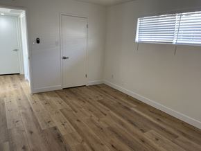 Phoenix apartment for rent - a bedroom with wooden floors and white walls and a door