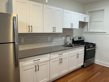 Phoenix apartment for rent - a kitchen with white cabinets and a sink and a refrigerator