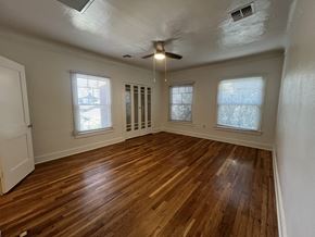 Phoenix apartment for rent - an empty living room with wood floors and a ceiling fan