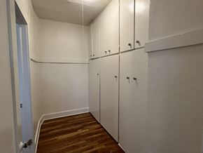 Phoenix apartment for rent - a bedroom with white cabinets and a wood floor